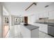 Bright kitchen with white cabinets, an island cooktop, and a view of the backyard patio at 172 Hawthorn Dr., Pawleys Island, SC 29585