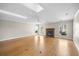 Bright living room with hardwood floors, a fireplace, large windows, and a ceiling fan at 172 Hawthorn Dr., Pawleys Island, SC 29585