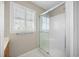 Bright bathroom featuring glass-enclosed shower and window with shutters at 172 Hawthorn Dr., Pawleys Island, SC 29585