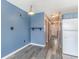 A hallway leading to a kitchen showing blue walls and wood look flooring at 1881 Colony Dr. # 8-S, Surfside Beach, SC 29575