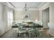 Bright dining room with table set for six, chandelier lighting, and a rug to complete the room at 2017 Lone Cypress Dr, Myrtle Beach, SC 29579