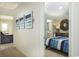 Hallway view into a bedroom with a large dresser, decorated walls and an attached bathroom at 2017 Lone Cypress Dr, Myrtle Beach, SC 29579