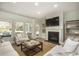 Cozy living room features a fireplace, mantle, built in shelving, comfortable seating and large windows at 2017 Lone Cypress Dr, Myrtle Beach, SC 29579