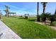 Beachfront lawn featuring a swing, covered bench, palm trees, and manicured grass at 205 74Th Ave. N # 702, Myrtle Beach, SC 29572