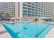 Large outdoor pool with plenty of lounge chairs and a colorful splash area for at a high rise condominium at 205 74Th Ave. N # 702, Myrtle Beach, SC 29572