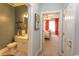 Hallway view showcasing a bathroom and a bedroom with bright orange curtains at 2241 Waterview Dr. # 224, North Myrtle Beach, SC 29582