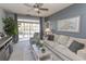 Comfortable living room featuring a neutral sofa, accent chair, and view to the outdoor deck at 2241 Waterview Dr. # 224, North Myrtle Beach, SC 29582