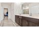 Modern bathroom featuring double sinks, granite countertop, and a large mirror, offering both style and functionality at 2321 Copper Creek Loop, Longs, SC 29568