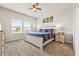 Comfortable bedroom featuring a ceiling fan, large window, and a cozy bed with stylish decor at 2321 Copper Creek Loop, Longs, SC 29568