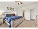 Comfortable bedroom featuring a queen-sized bed with blue bedding and light wood furniture at 2321 Copper Creek Loop, Longs, SC 29568