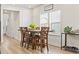 Bright dining room with wood floors, large windows, and a wooden table with six chairs at 2321 Copper Creek Loop, Longs, SC 29568