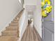 Inviting foyer with wood floors, a staircase, and a welcoming wreath on the front door at 2321 Copper Creek Loop, Longs, SC 29568