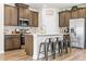 Contemporary kitchen with stainless steel appliances, an island with seating, and wood flooring at 2321 Copper Creek Loop, Longs, SC 29568