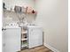 This laundry room features a washer, dryer, and convenient shelving for storage at 2321 Copper Creek Loop, Longs, SC 29568