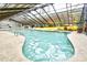 The indoor pool area has slides, lounge chairs, and glass ceiling at 2401 S Ocean Blvd. # 854, Myrtle Beach, SC 29577