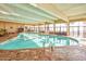 Spacious indoor pool with a brick surround, large windows, tables and chairs at 2401 S Ocean Blvd. # 854, Myrtle Beach, SC 29577