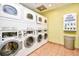 Clean laundry room featuring multiple washers, dryers, and a soap dispenser at 2401 S Ocean Blvd. # 854, Myrtle Beach, SC 29577