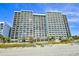 Exterior view of beachfront condo building with multiple stories and balconies at 2401 S Ocean Blvd. # 859, Myrtle Beach, SC 29577