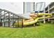 Exterior view of a building featuring a waterslide leading into an indoor pool area at 2401 S Ocean Blvd. # 859, Myrtle Beach, SC 29577