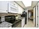 Efficient kitchen featuring black appliances, granite counters, mosaic backsplash, and light wood look flooring at 2401 S Ocean Blvd. # 953, Myrtle Beach, SC 29577