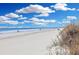 Scenic beach with white sand and rolling waves under a blue sky at 2405 S Ocean Blvd. # 304, North Myrtle Beach, SC 29582