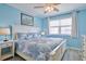 Relaxing bedroom with blue walls, a large window, and a comfortable queen-size bed at 2405 S Ocean Blvd. # 304, North Myrtle Beach, SC 29582