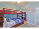 Bedroom showcasing bunk beds, wood laminate flooring and a mirrored closet at 2405 S Ocean Blvd. # 304, North Myrtle Beach, SC 29582