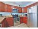 This kitchen features stainless steel appliances, wood cabinets, and a light granite countertop at 2405 S Ocean Blvd. # 304, North Myrtle Beach, SC 29582