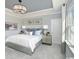 Relaxing bedroom with neutral colors, a tray ceiling, and a large window for natural light at 2534 Watershed Way, North Myrtle Beach, SC 29568