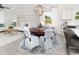 Bright, open-concept dining room with a round wooden table, seating for six, and modern chandelier at 2534 Watershed Way, North Myrtle Beach, SC 29568