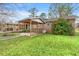 Brick house featuring a cozy, covered patio and a vibrant flowering bush, enhancing its outdoor appeal at 2560 Wise Rd., Conway, SC 29526