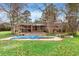 Spacious backyard featuring a covered porch, hot tub, and inviting pool area at 2560 Wise Rd., Conway, SC 29526