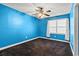 Bright blue bedroom with a ceiling fan and window with curtains at 2560 Wise Rd., Conway, SC 29526