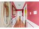 View of the home's entryway showcasing vibrant red walls with white trim and wood-look flooring at 2560 Wise Rd., Conway, SC 29526