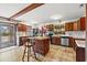 Well-lit kitchen open to living space features an island and exposed beam ceiling at 2560 Wise Rd., Conway, SC 29526