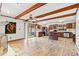 Open-concept living space showcases wood beam ceilings and a seamless transition to the kitchen at 2560 Wise Rd., Conway, SC 29526