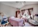 Bright bedroom with window and ceiling fan features carpeted floors and a large dresser at 305 Aqua Vista Ct., Myrtle Beach, SC 29588