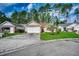 Charming single-story home with a well-manicured front yard, concrete driveway, and attached two-car garage at 305 Aqua Vista Ct., Myrtle Beach, SC 29588