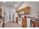 Functional kitchen featuring tiled flooring, essential appliances, and wood cabinetry at 305 Aqua Vista Ct., Myrtle Beach, SC 29588