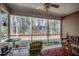 Relaxing screened porch featuring ceiling fan, outdoor furniture, and views of the private, wooded backyard at 305 Aqua Vista Ct., Myrtle Beach, SC 29588