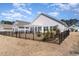 Spacious backyard with black fencing and a pergola covered patio at 3074 Viceroy Loop, Little River, SC 29566