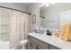 Well-lit bathroom with floral shower curtain, a large mirror, and vanity at 3074 Viceroy Loop, Little River, SC 29566