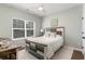 Cozy bedroom with natural light, a decorative bed, and a rustic wooden desk at 3074 Viceroy Loop, Little River, SC 29566