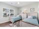 Charming bedroom featuring two twin beds, wood floors, dresser and lots of natural light at 3074 Viceroy Loop, Little River, SC 29566