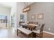 Inviting dining room with modern chandelier, stylish wallpaper and a beautiful wooden table at 3074 Viceroy Loop, Little River, SC 29566