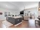 Open-concept living room featuring an island kitchen, fireplace, and abundant natural light at 3074 Viceroy Loop, Little River, SC 29566