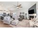 Open-concept living room flows into the kitchen with fireplace, neutral decor, and spacious seating at 3074 Viceroy Loop, Little River, SC 29566