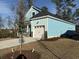 Light blue two-story home featuring an attached garage, stone accents, and newly installed sod at 3121 Tiger Tail Rd., Conway, SC 29526