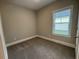 This bedroom offers neutral walls, plush carpeting, and natural light from a window at 3135 Tiger Tail Rd., Conway, SC 29526