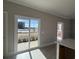 A dining area has a sliding glass door leading outside and is bathed in sunlight, with light wood floors at 3135 Tiger Tail Rd., Conway, SC 29526